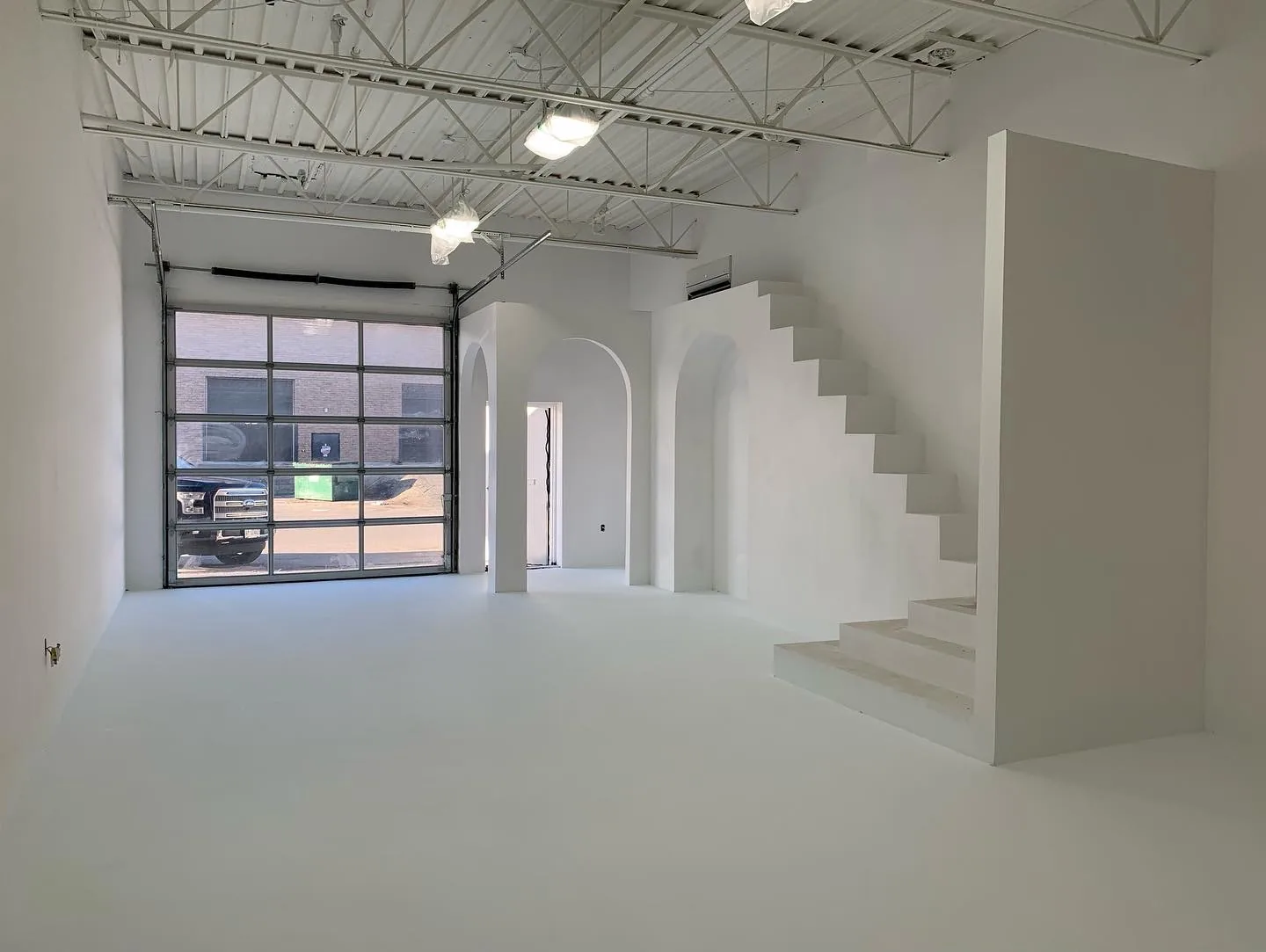 Finished commercial unit with custom drywall staircase