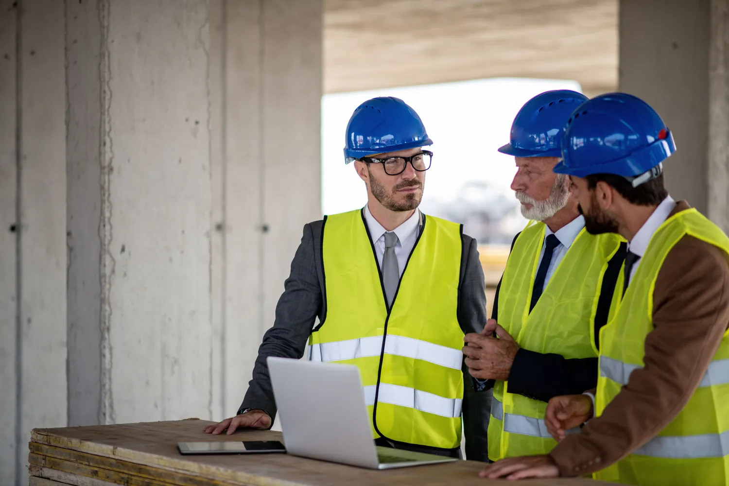 Project team reviewing plans on site