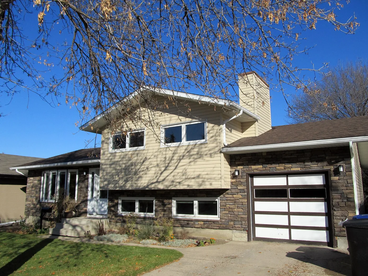 Renovated house exterior with new garage door