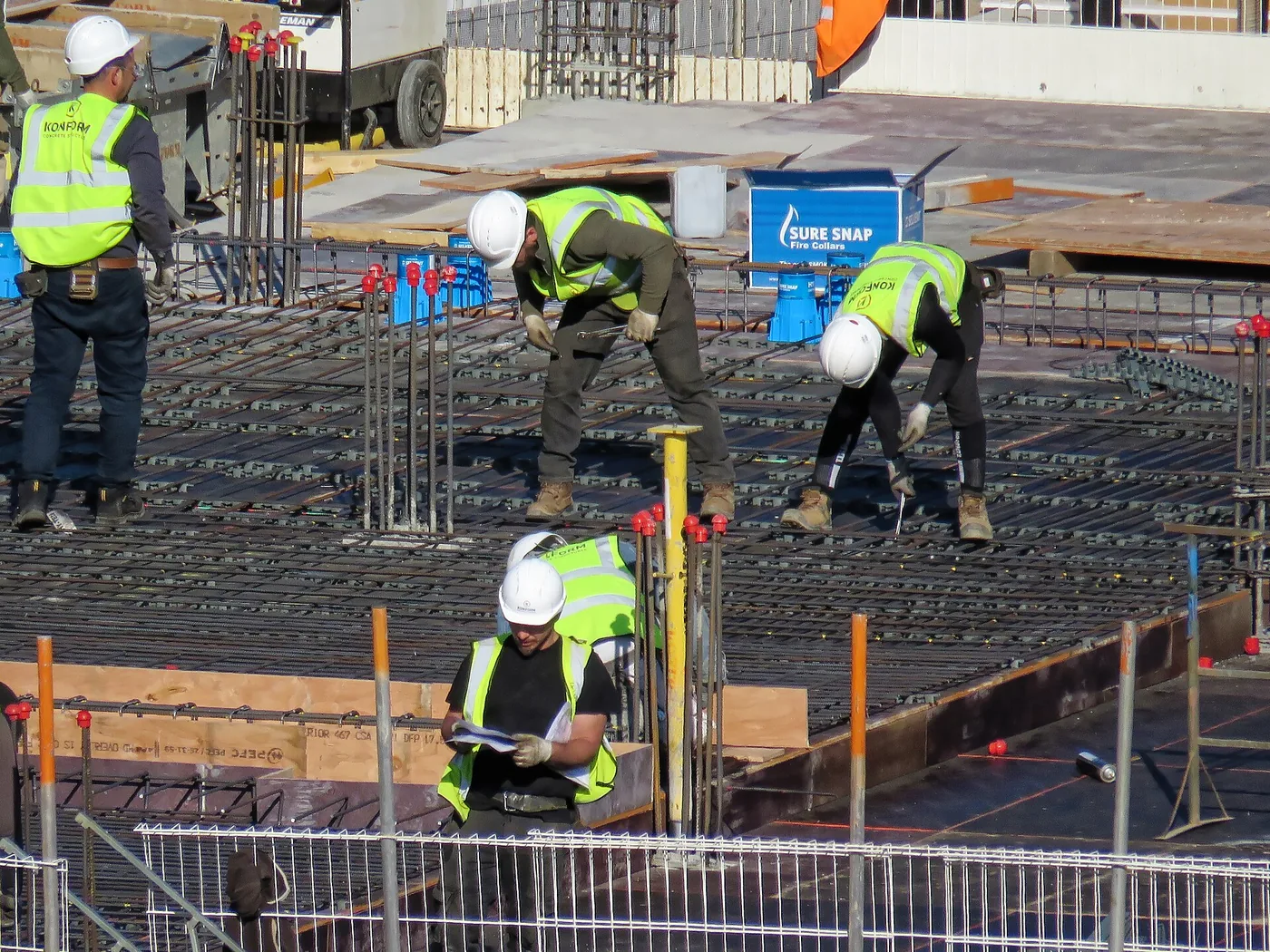 Licensed crew placing rebar on a job site