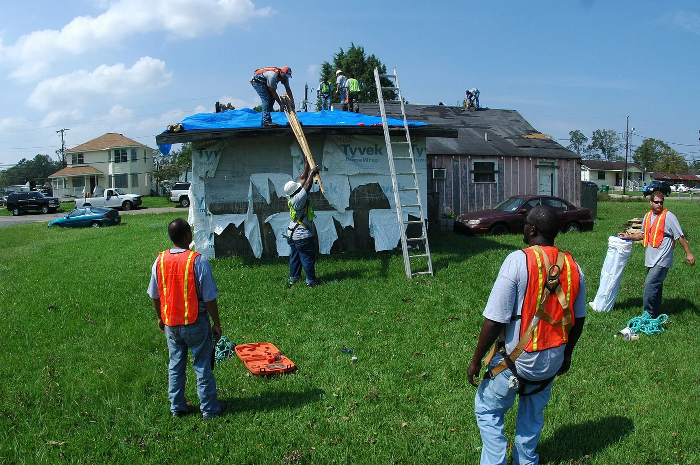 Crew tarping a storm-damaged roof