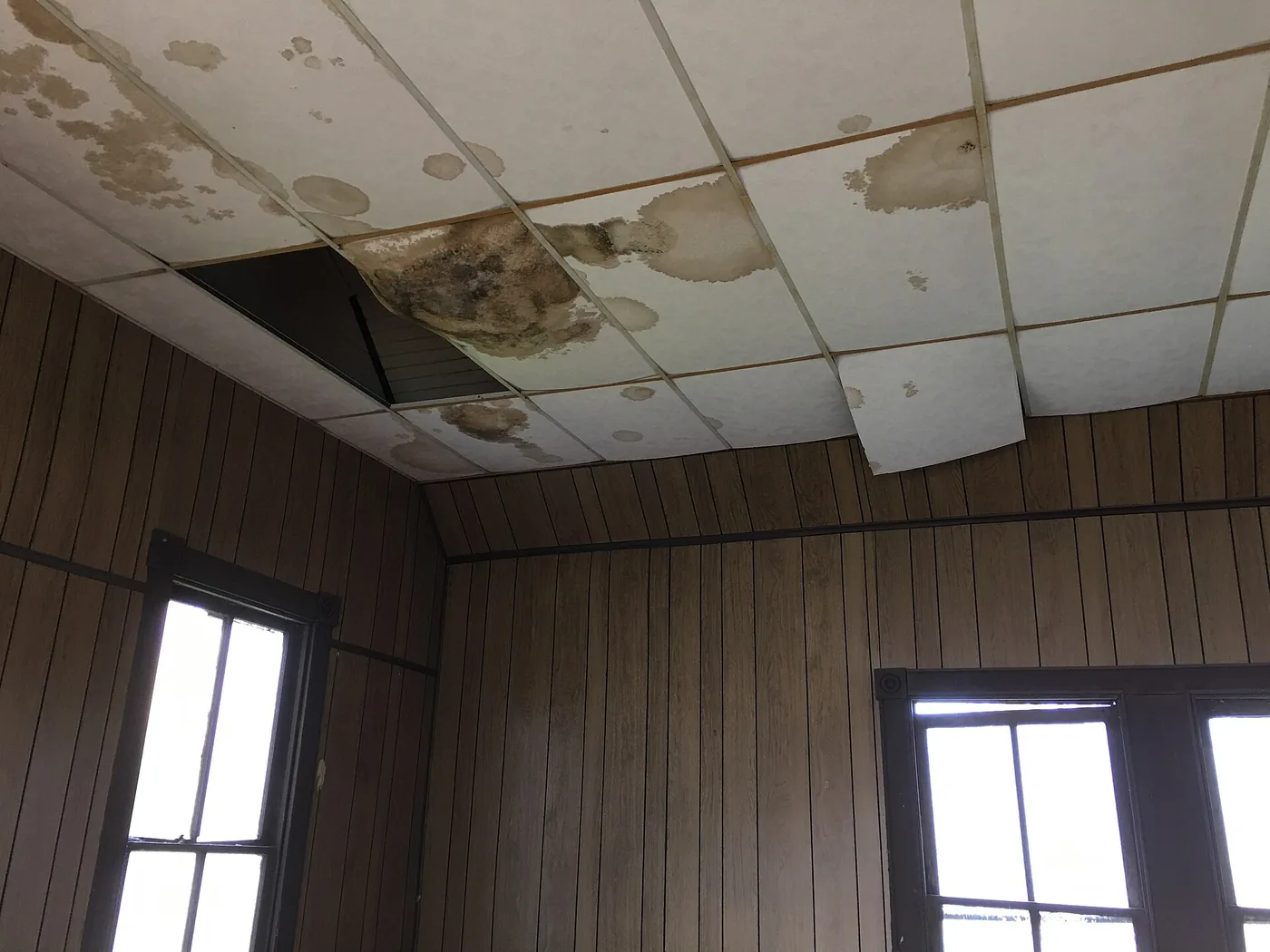 Ceiling tiles stained and fallen from a leak