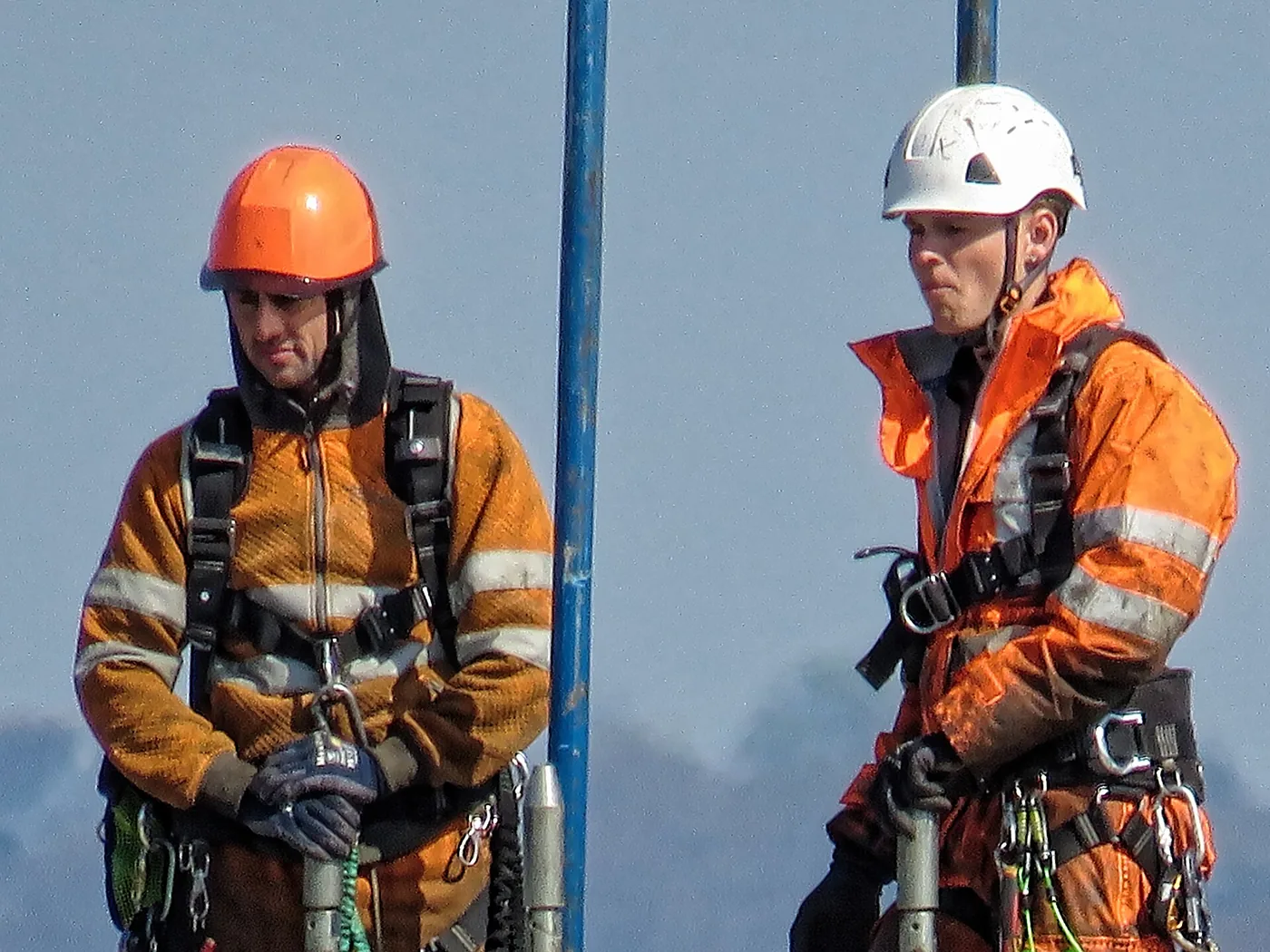 Two construction workers in hard hats on site